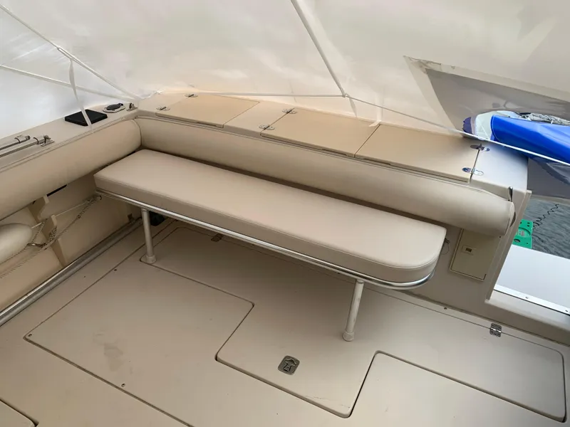 Slide: The Image of 2006 Albin 28 Tournament Express boat interior with beige seating and storage compartments. - 18