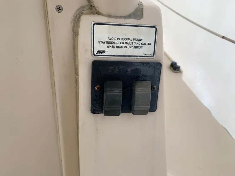 Slide: The Image of 2006 Albin 28 Tournament Express boat control panel with safety warning label. - 21