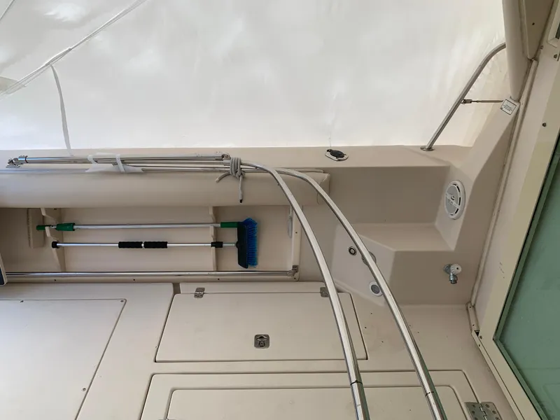 Slide: The Image of 2006 Albin 28 Tournament Express interior with storage compartments and cleaning tools. - 22