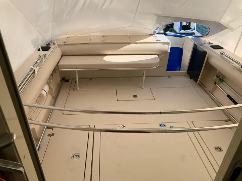 Slide: The Image of 2006 Albin 28 Tournament Express boat interior with beige seating and storage compartments. - 24