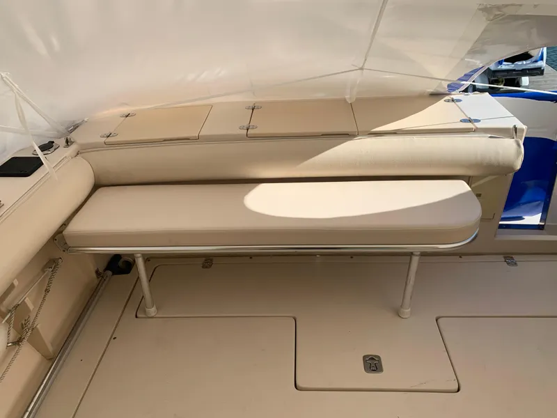 Slide: The Image of 2006 Albin 28 Tournament Express interior seating area with beige cushions. - 25
