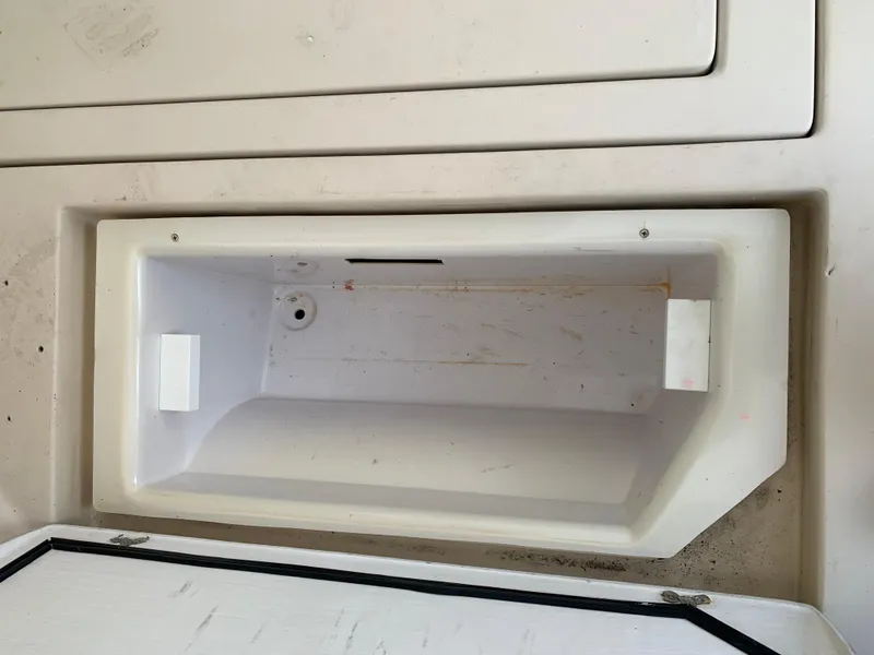 Slide: The Image of Open storage compartment on a 2006 Albin 28 Tournament Express boat. - 26