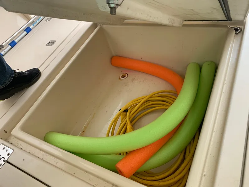 Slide: The Image of Storage compartment on 2006 Albin 28 Tournament Express with pool noodles and yellow rope. - 27
