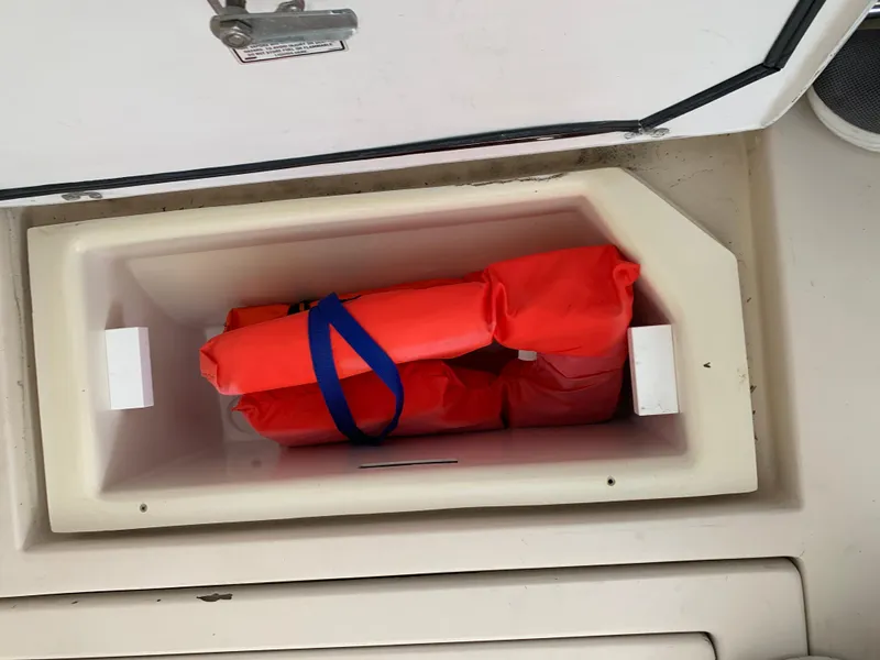 Slide: The Image of Storage compartment with life jackets on a 2006 Albin 28 Tournament Express boat. - 28
