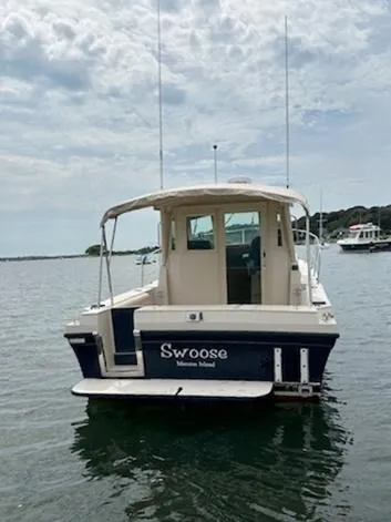 Slide: The Image of 2006 Albin 28 Tournament Express boat on calm water, rear view. - 3