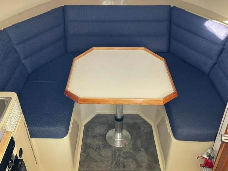 Slide: The Image of 2006 Albin 28 Tournament Express interior with blue seating and octagonal table. - 32