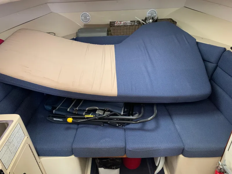Slide: The Image of 2006 Albin 28 Tournament Express cabin interior with blue cushions and folded mattress. - 33