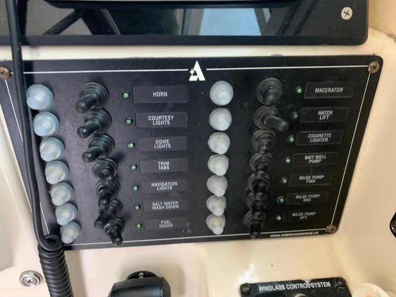 Slide: The Image of Control panel of a 2006 Albin 28 Tournament Express boat with various switches and indicators. - 47