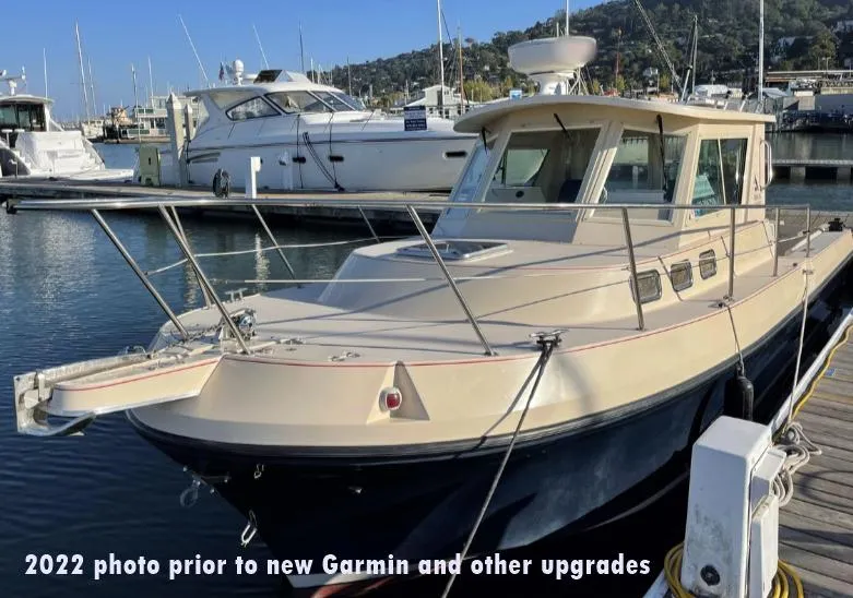 Slide: The Image of 2006 Albin 28 Tournament Express docked, pre-2022 Garmin upgrades, in a marina setting. - 5
