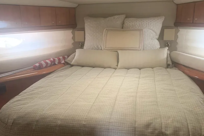 Slide: The Image of Luxurious bedroom interior of 2003 Sunseeker Predator 62 yacht with plush bedding. - 13
