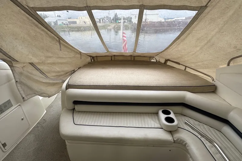 Slide: The Image of 2003 Sunseeker Predator 62 yacht interior with cushioned seating and canopy. - 20