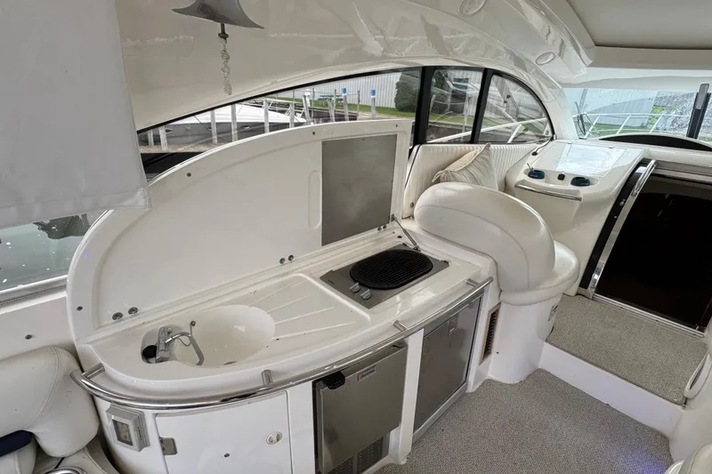 Slide: The Image of 2003 Sunseeker Predator 62 yacht interior with kitchenette and seating area. - 22