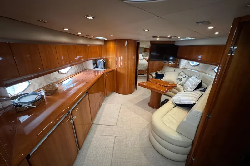 Slide: The Image of Luxurious interior of 2003 Sunseeker Predator 62 yacht with elegant wood finishes and cozy seating. - 24