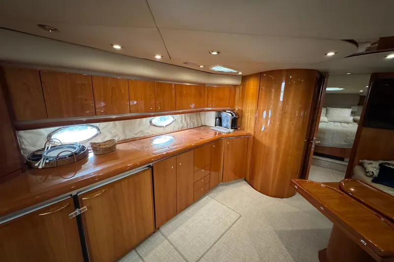 Slide: The Image of Luxurious interior of 2003 Sunseeker Predator 62 yacht with wooden cabinetry and modern amenities. - 28