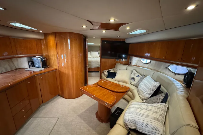 Slide: The Image of Luxurious interior of 2003 Sunseeker Predator 62 yacht with plush seating and wooden finishes. - 29