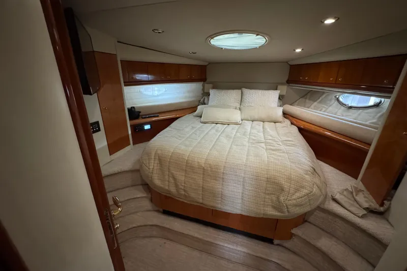 Slide: The Image of Luxurious bedroom interior of 2003 Sunseeker Predator 62 yacht with elegant wood finishes. - 30