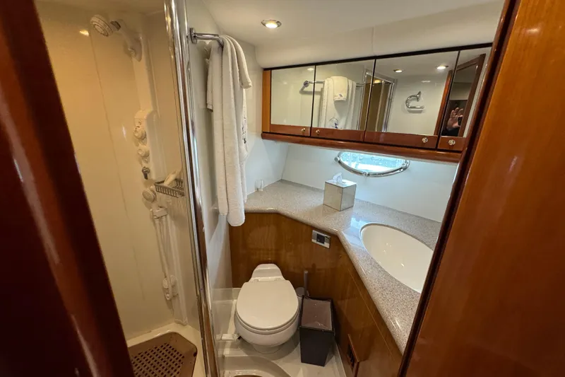 Slide: The Image of Luxurious bathroom in 2003 Sunseeker Predator 62 yacht with modern fixtures and elegant wood finishes. - 32