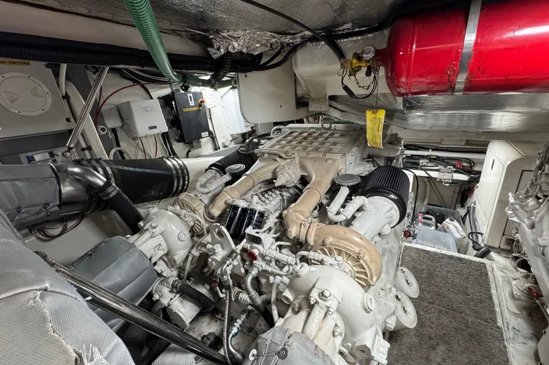 Slide: The Image of Engine room of a 2003 Sunseeker Predator 62 yacht, featuring complex machinery and equipment. - 34