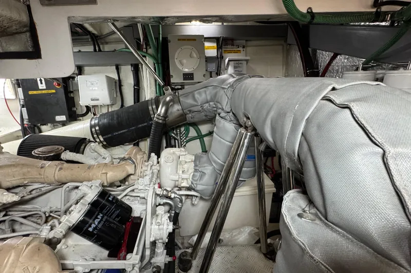 Slide: The Image of Engine room of a 2003 Sunseeker Predator 62 yacht, showcasing mechanical components. - 36