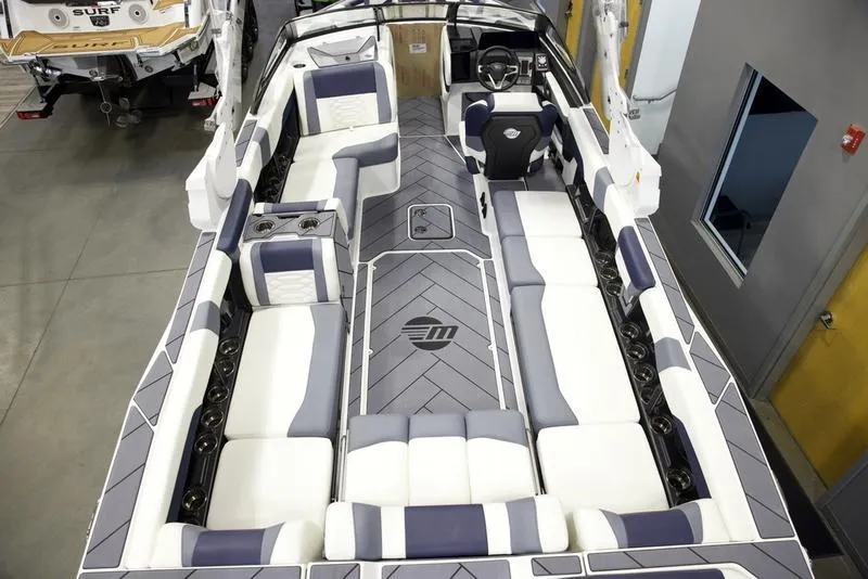 Slide: The Image of 2025 Malibu 26 LSV boat interior with luxurious seating and modern design. - 12