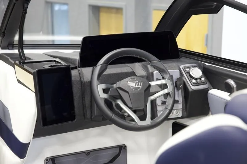 Slide: The Image of 2025 Malibu 26 LSV boat dashboard with modern steering and digital controls. - 14