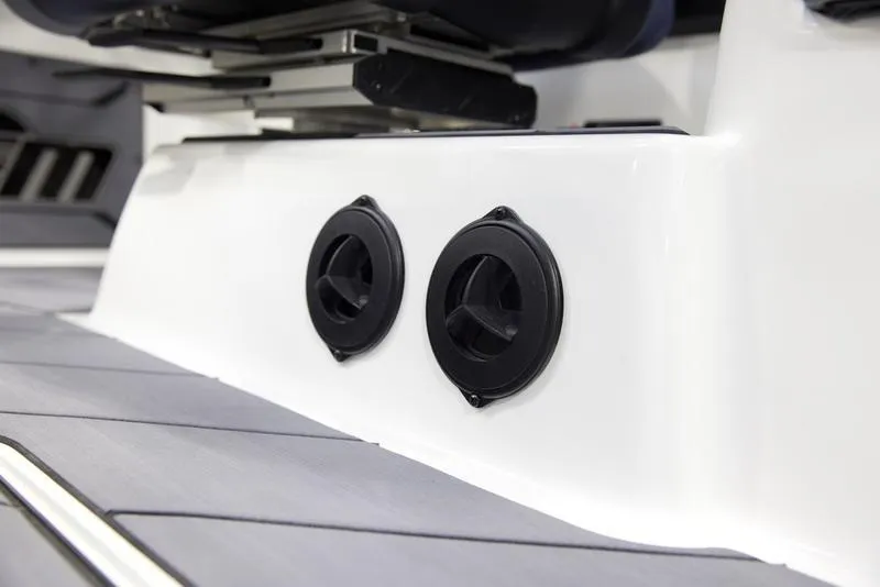 Slide: The Image of 2025 Malibu 26 LSV boat interior with dual black speakers. - 16