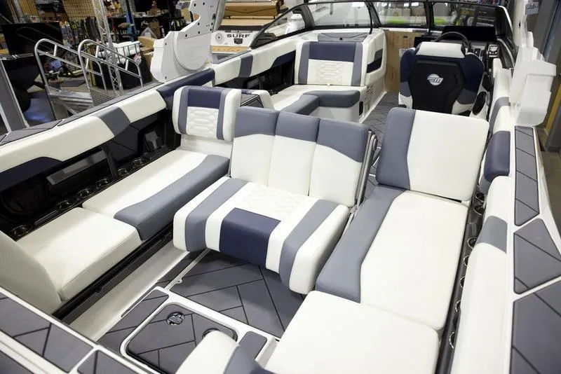 Slide: The Image of 2025 Malibu 26 LSV boat interior with luxurious seating and modern design. - 23