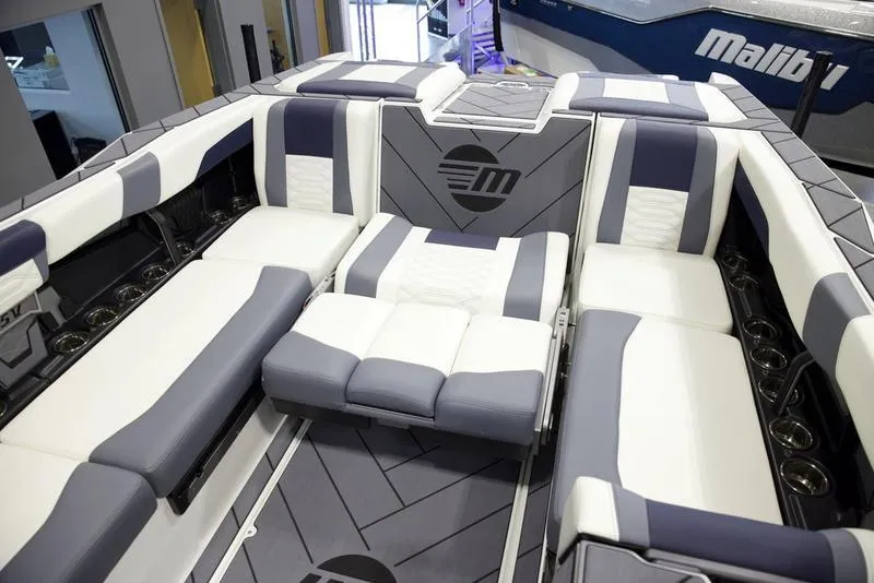 Slide: The Image of 2025 Malibu 26 LSV boat interior with luxurious seating and modern design. - 24