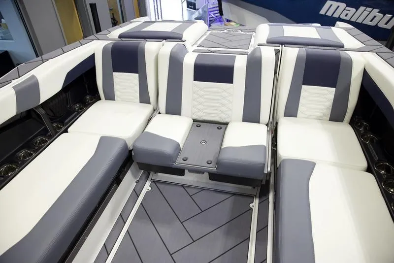 Slide: The Image of 2025 Malibu 26 LSV boat interior with white and gray seating, modern design. - 25