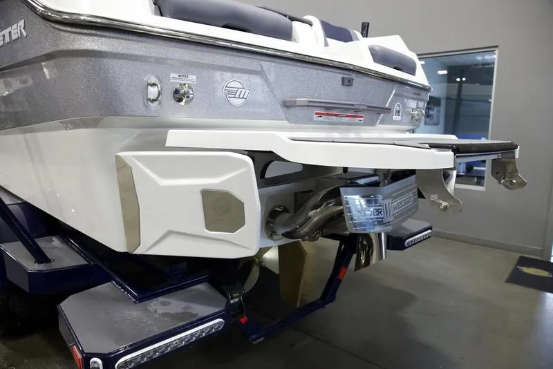 Slide: The Image of 2025 Malibu 26 LSV boat rear view in showroom, showcasing sleek design and features. - 5