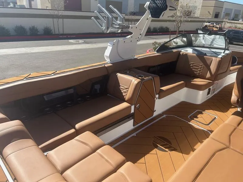 Slide: The Image of 2025 Malibu 26 LSV boat interior with tan leather seating and sleek design. - 13