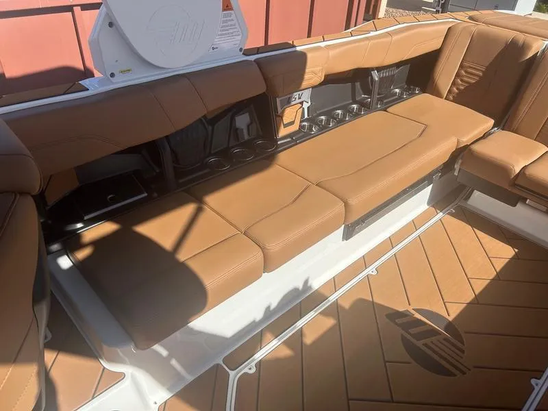 Slide: The Image of 2025 Malibu 26 LSV boat interior with tan leather seating and modern design. - 17