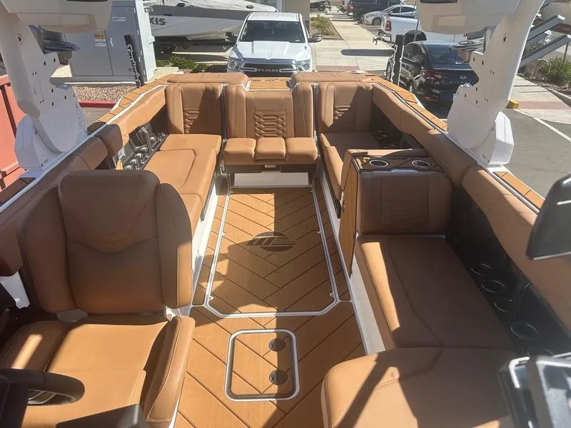 Slide: The Image of Luxurious interior of 2025 Malibu 26 LSV boat with tan leather seating. - 18