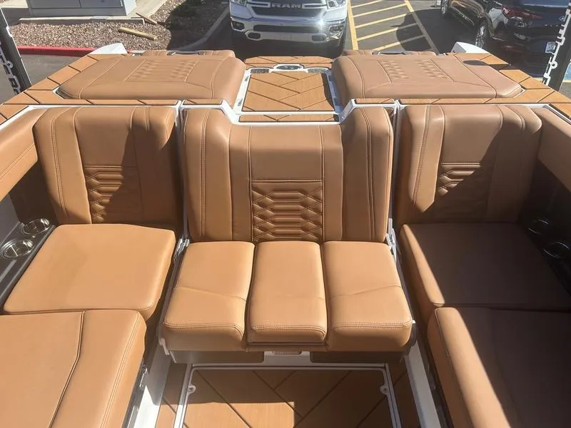 Slide: The Image of 2025 Malibu 26 LSV boat interior with tan leather seating and modern design. - 19