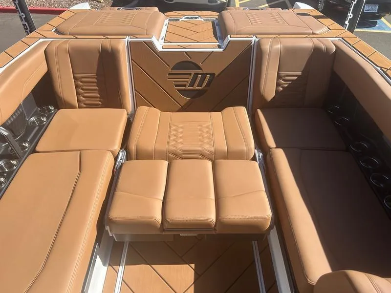 Slide: The Image of 2025 Malibu 26 LSV boat interior with tan leather seating and stylish design. - 21