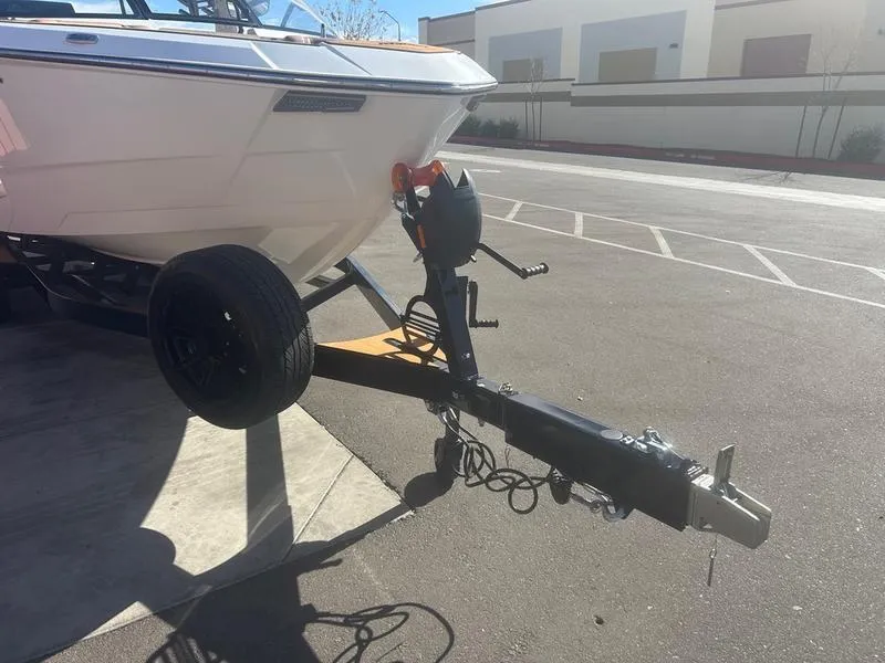 Slide: The Image of 2025 Malibu 26 LSV boat on trailer in parking lot. - 6