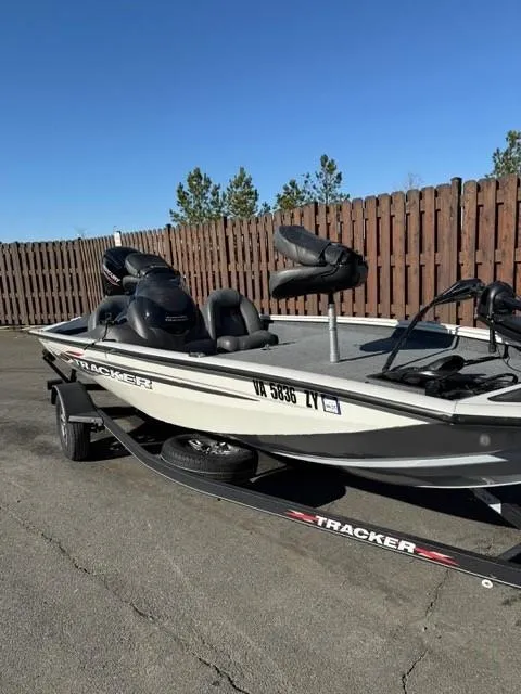 Slide: The Image of 2022 Tracker PRO175TE boat on trailer, parked outdoors near wooden fence. - 5