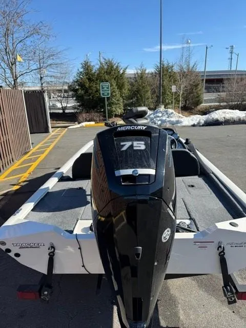 Slide: The Image of 2022 Tracker PRO175TE boat with Mercury 75 engine in a parking lot. - 6