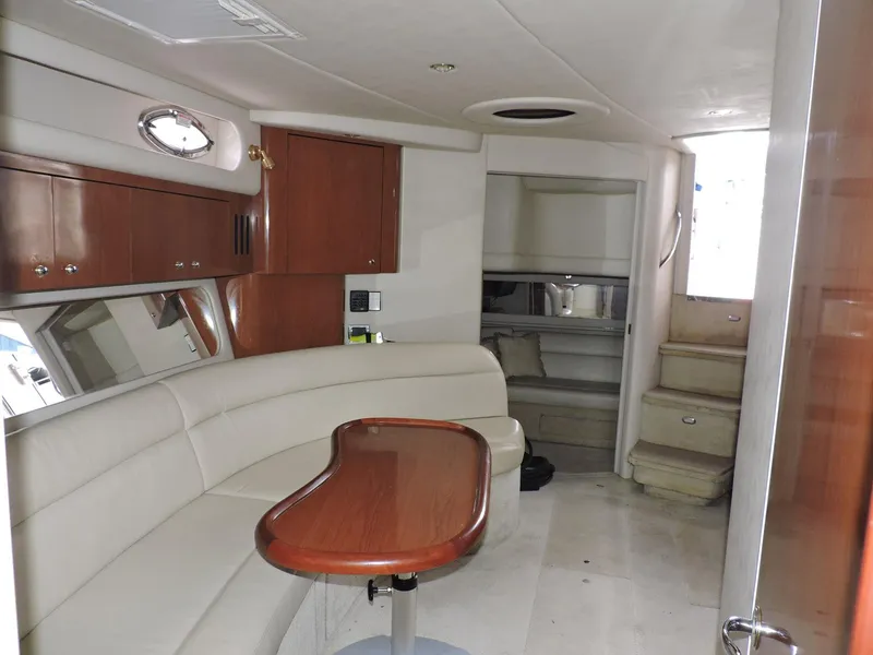 Slide: The Image of Interior of 2002 Sea Ray 410 Sundancer yacht with elegant seating and wooden table. - 2