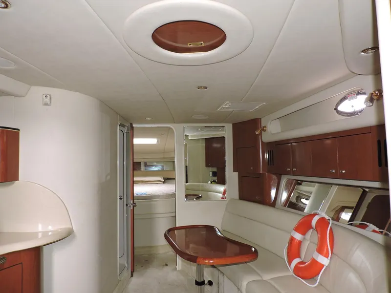 Slide: The Image of Interior of 2002 Sea Ray 410 Sundancer yacht with elegant seating and wooden accents. - 4