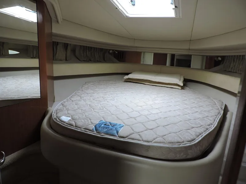 Slide: The Image of Interior cabin of 2002 Sea Ray 410 Sundancer with a round bed and skylight. - 5
