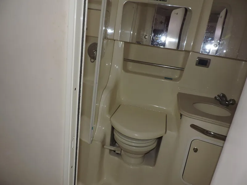 Slide: The Image of Bathroom interior of 2002 Sea Ray 410 Sundancer yacht, featuring toilet and sink. - 6