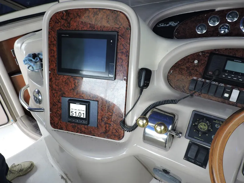 Slide: The Image of Control panel of a 2002 Sea Ray 410 Sundancer boat, featuring navigation and communication equipment. - 9
