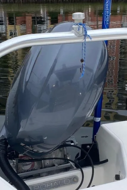 Slide: The Image of 2016 Robalo 226 Cayman boat engine, docked on calm water. - 14