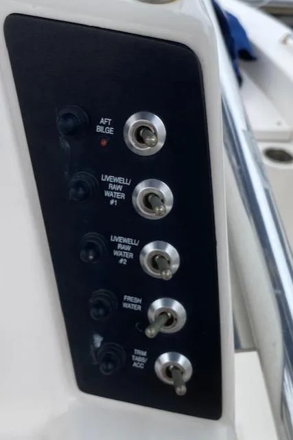 Slide: The Image of Control panel of a 2016 Robalo 226 Cayman boat with various switches. - 17