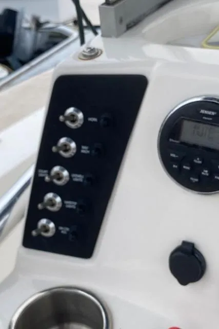 Slide: The Image of Control panel of a 2016 Robalo 226 Cayman boat with switches and a digital display. - 18