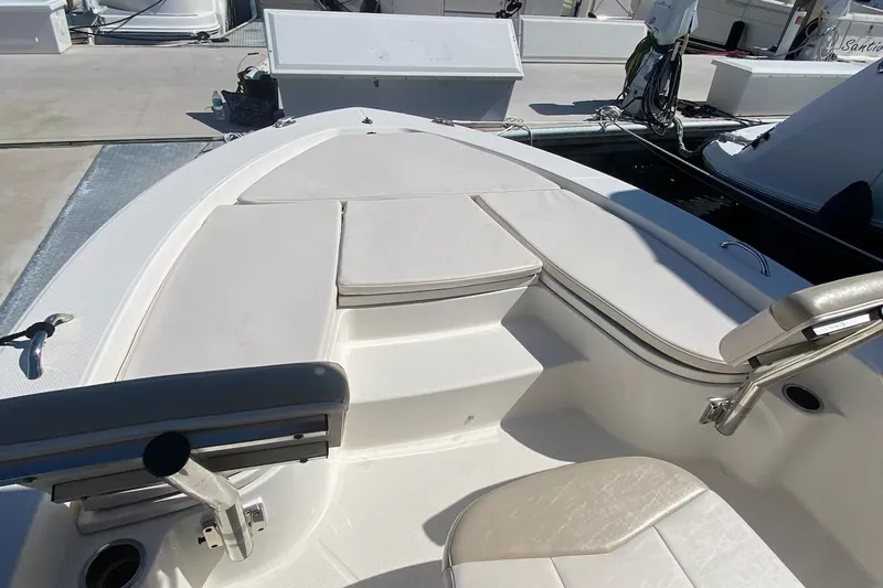 Slide: The Image of 2016 Robalo 226 Cayman boat interior with cushioned seating and storage compartments. - 25