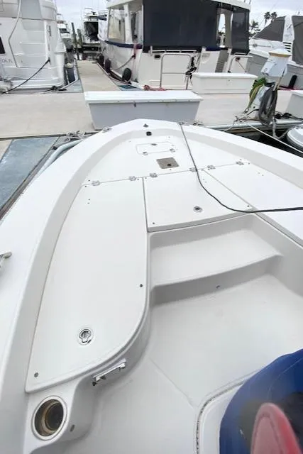 Slide: The Image of 2016 Robalo 226 Cayman boat docked at marina, showcasing spacious deck layout. - 26