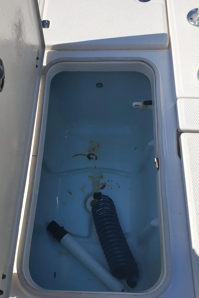 Slide: The Image of Open storage compartment on a 2016 Robalo 226 Cayman boat. - 27