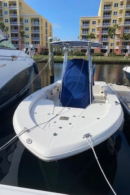 Slide: The Image of 2016 Robalo 226 Cayman boat docked near waterfront buildings. - 8